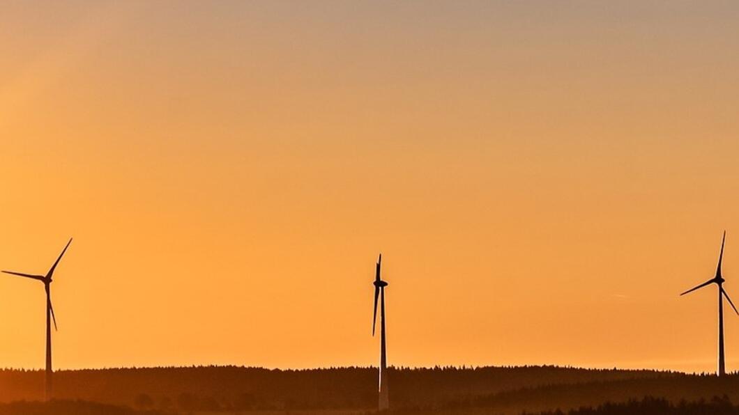 3 windmolens bij ondergaande zon